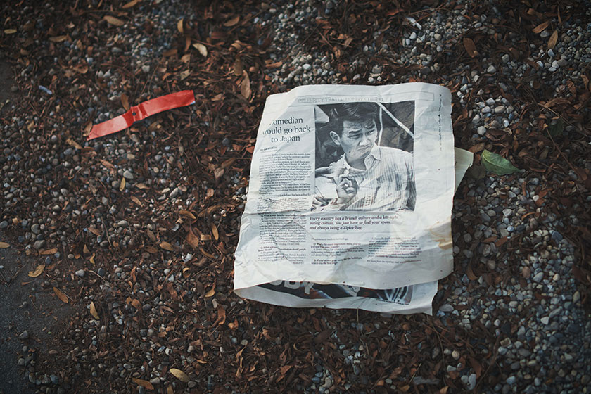 newspaper on ground still life
