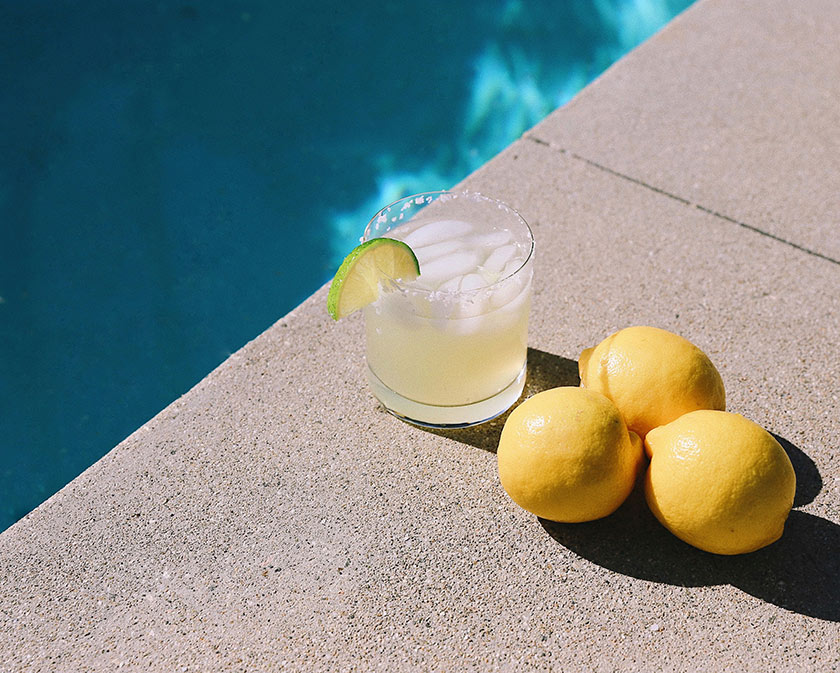 still life lemons and lemonade on pool deck